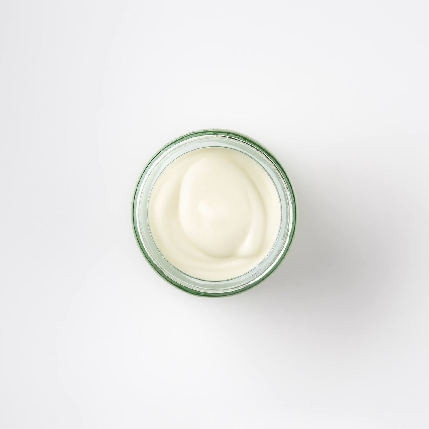view of the top of a Bristolmade body balm, showing the glossy cream colour of the product and it smooth, silky texture.