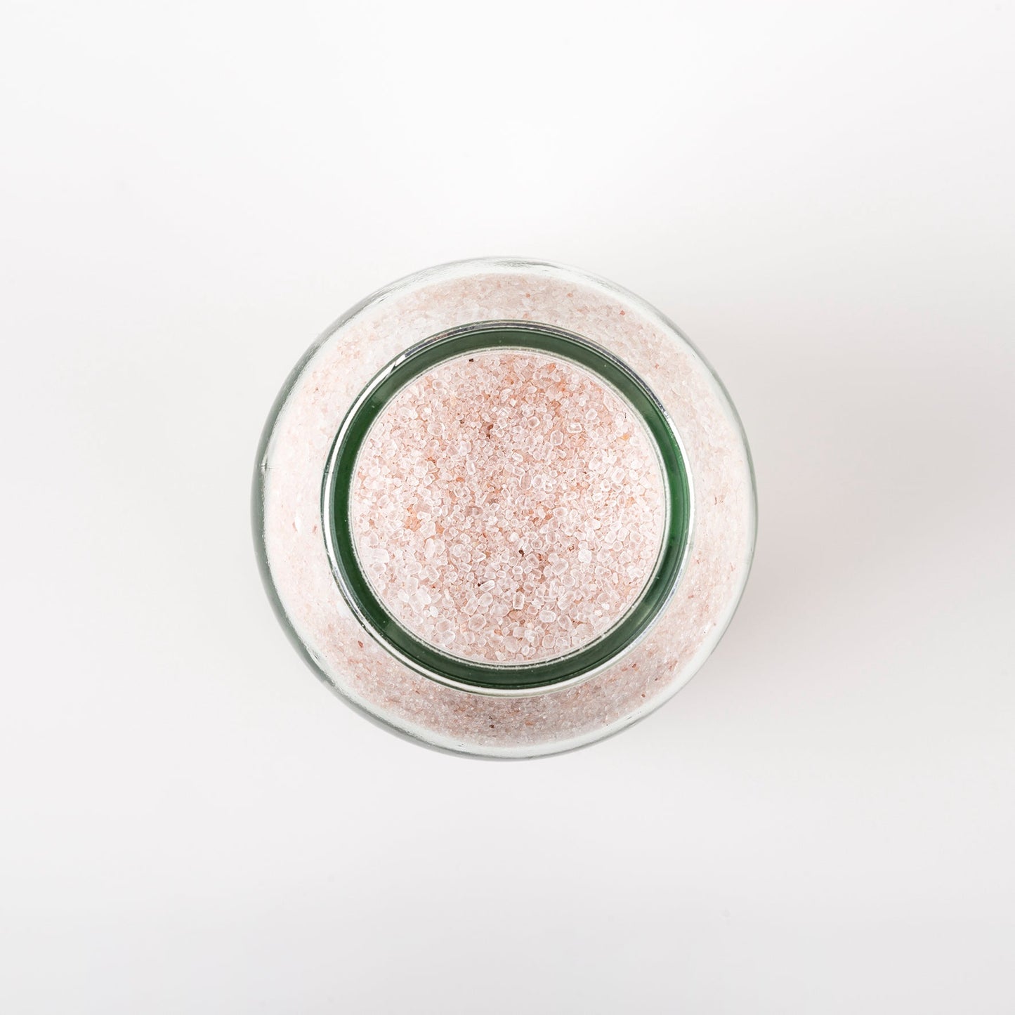 photo of the top view of Drift Deeply Bath Salts Lavender & Vanilla a jar of bath salts, showing the pale pink grains of the epsom and himalayan salts.