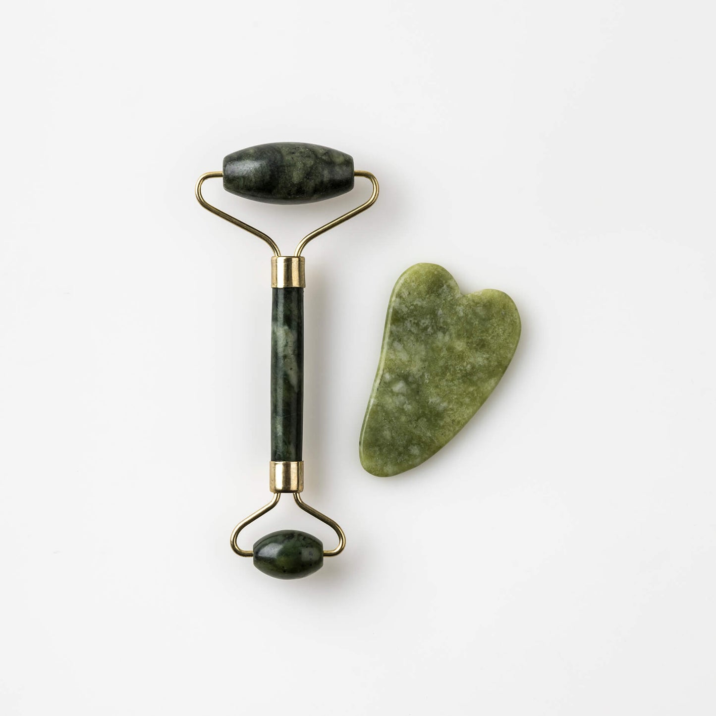 A Bristolmade Jade Roller & Gua Sha Stone, featuring smooth green jade rollers with gold coloured fittings and a matching jade gua sha tool, both designed for facial massage and skincare.
