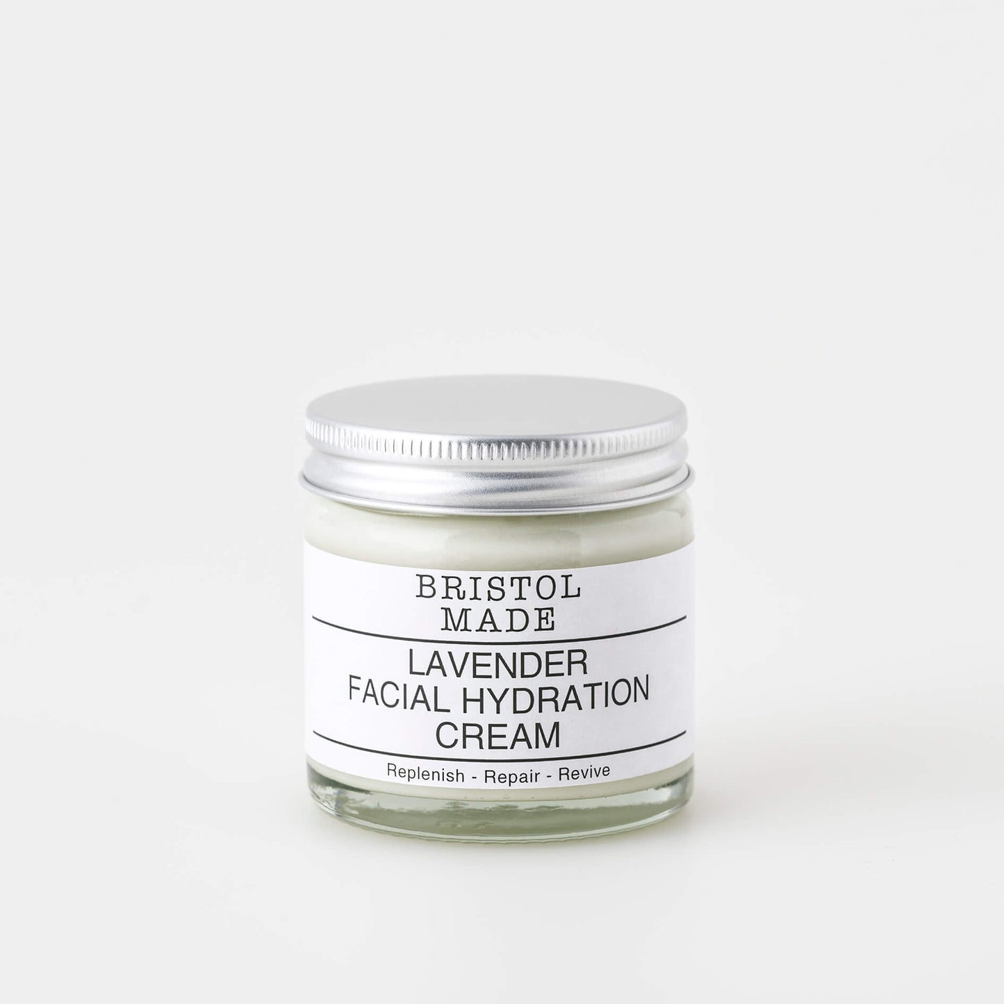 A 60ml clear glass jar of Bristolmade lavender face cream, featuring a white label with black text, highlighting it's vegan ingredients.