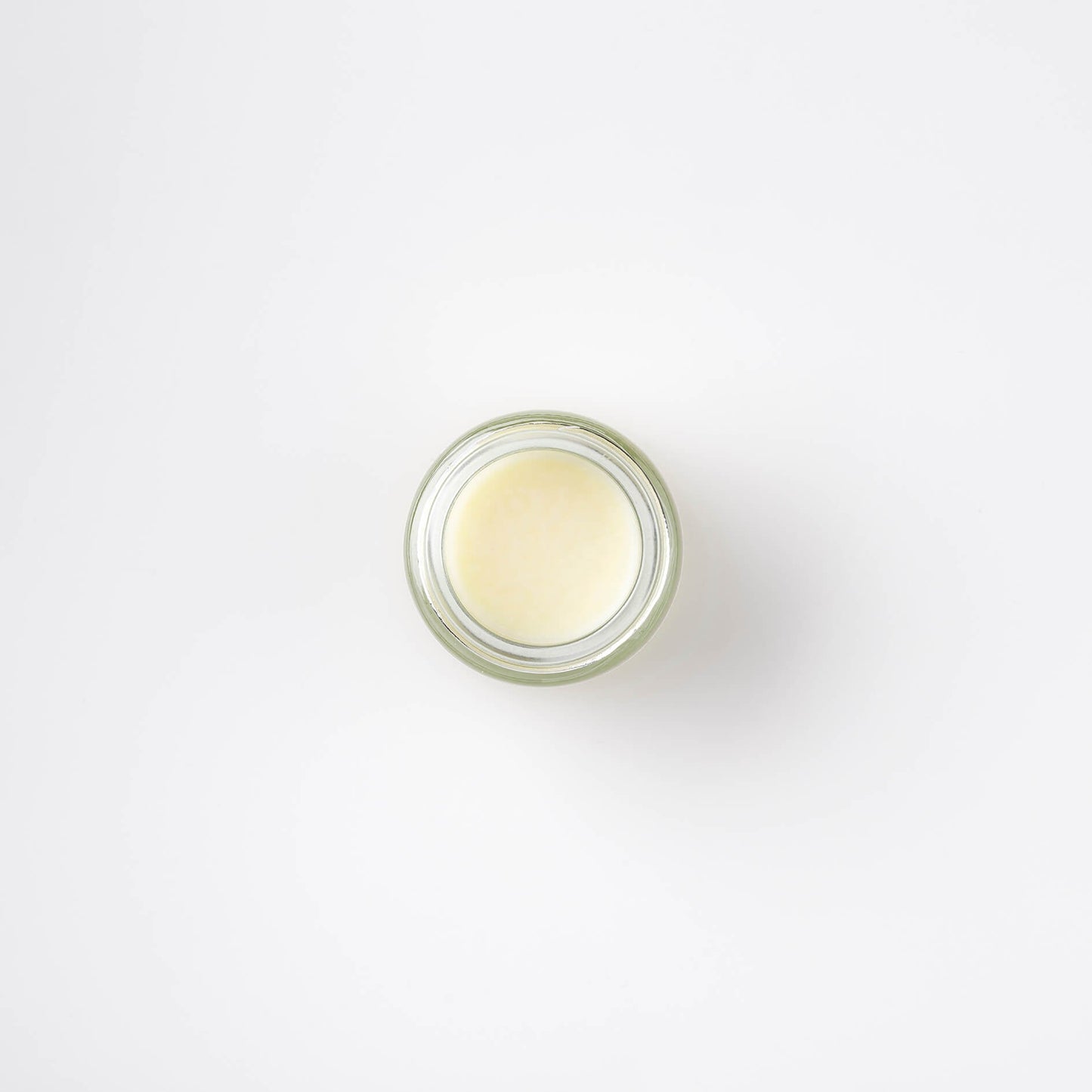 an image of four different Bristolmade lip balms, making a Lip Treatment Gift Set in 15ml clear glass jars, with white labels and black text, showing the different scents and ingredients of each product.