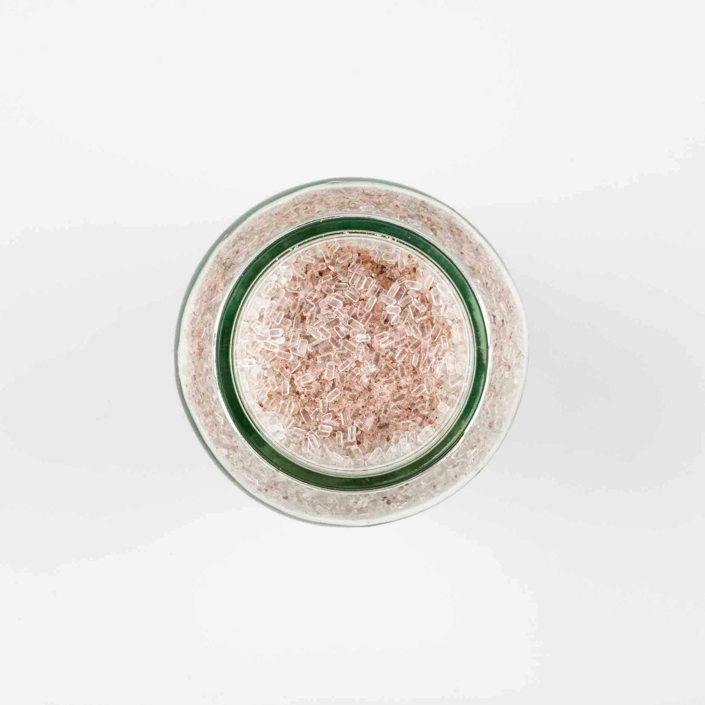 MELLOW BATH SALTS ROSE GERANIUM top view of a clear glass jar of pale pink bath salts made by The Joy of Meno brand